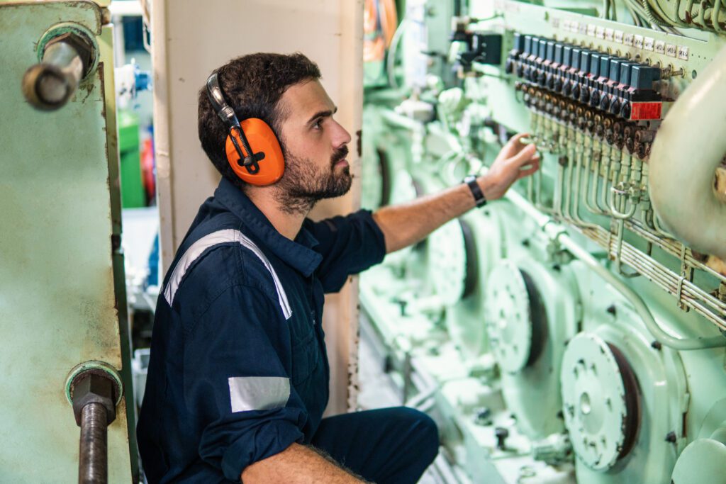 An engineer works in the engine control room.